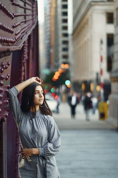 young lady crossing the bridge in the city