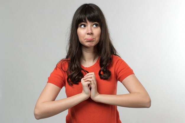 young lady in designed t-shirt thinking with long hair on white