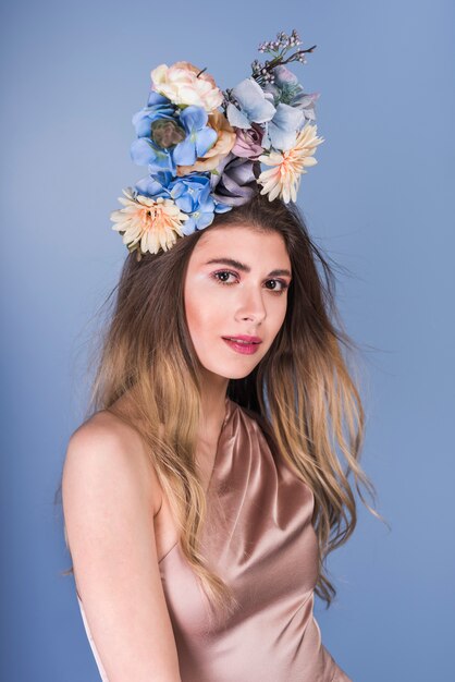 Young lady in dress with beautiful flowers on head