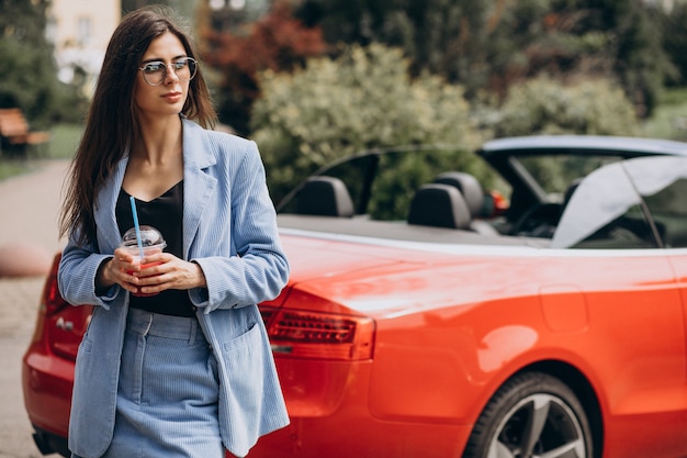 Young lady drinking ice drink outside the street