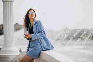 Free photo young lady drinking ice tea in park