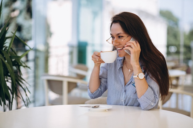 Young lady drinking tea in a cafe