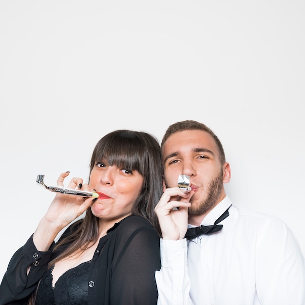 Young lady and guy in evening wear with party flutes