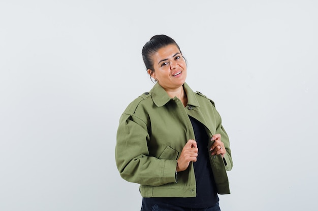 Young lady holding her open jacket in t-shirt