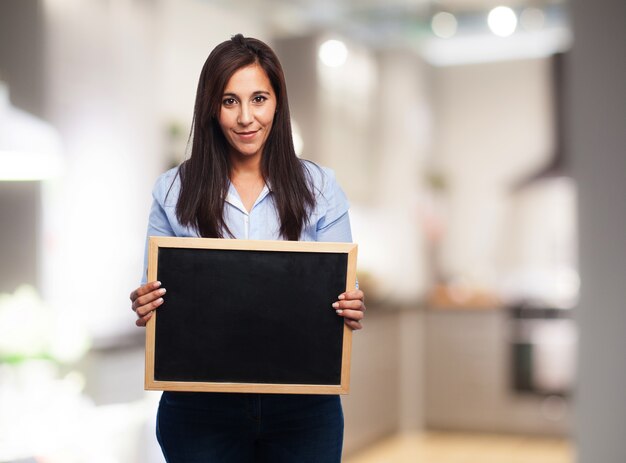 Young lady holding a small blackboard