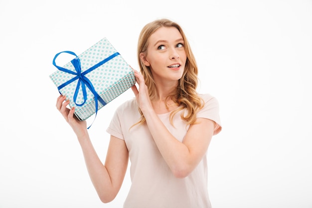 Free photo young lady holding surprise gift box.