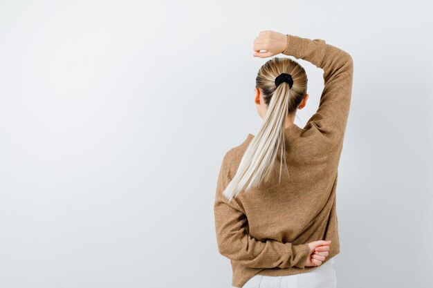 The young lady is showing her spine on white background