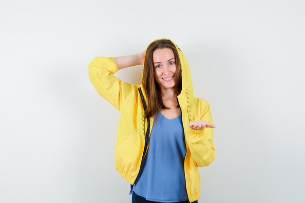 Young lady keeping raised palm open in t-shirt, jacket and looking confident