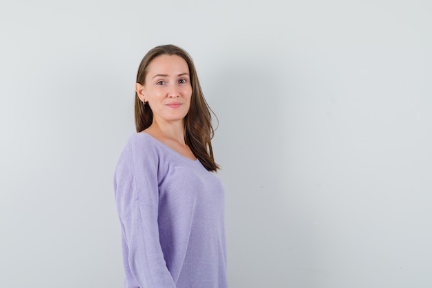 Young lady looking at camera in casual shirt and looking confident. front view.