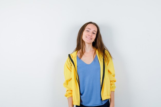 Young lady looking at camera in t-shirt, jacket and looking confident, front view.