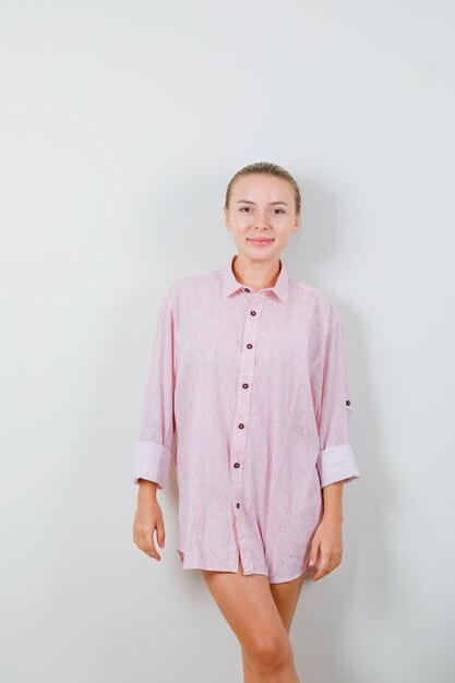 Young lady looking in pink shirt and looking glamorous