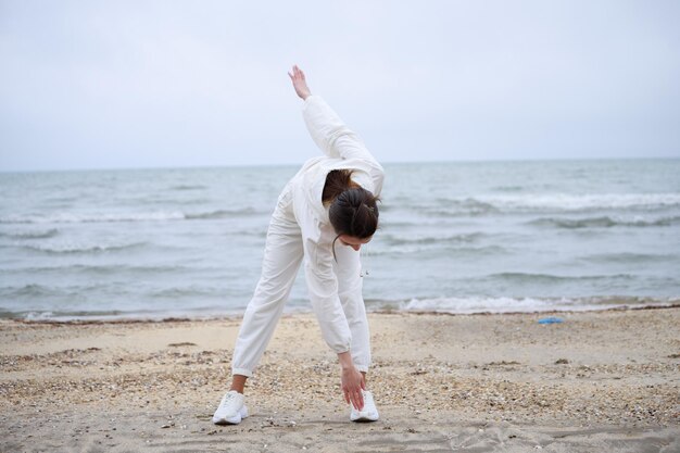 Young lady making her body warm before running High quality photo