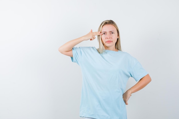 Free photo young lady making suicide gesture in t-shirt and looking hopeless isolated