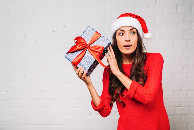 Young lady in party hat with present box 