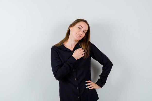 Young lady posing while holding hand on chest