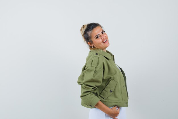 Young lady posing while standing in t-shirt jacket and looking charming 