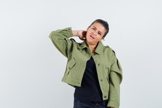 Young lady posing while standing in t-shirt