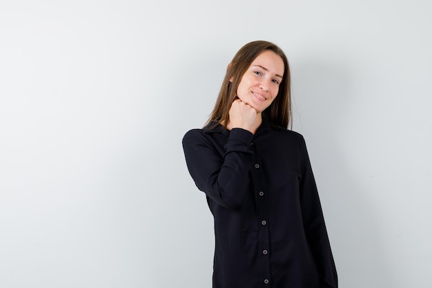 Young lady propping chin on fist