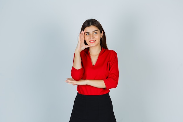 Youthful Woman in Red Blouse and Skirt Embracing Happiness