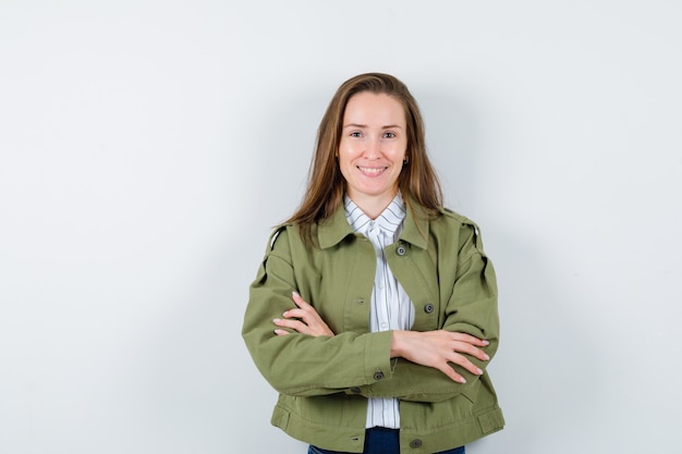 Free photo young lady in shirt, jacket standing with crossed arms and looking confident, front view.