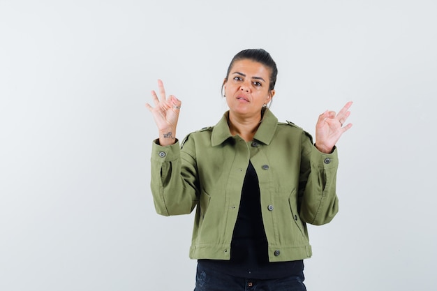 Young lady showing meditation gesture in t-shirt