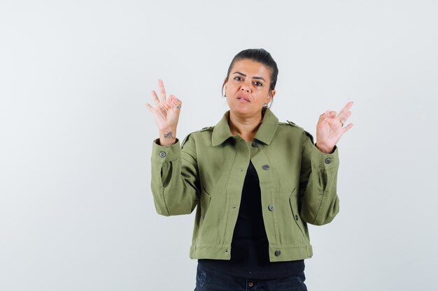 Young lady showing meditation gesture in t-shirt