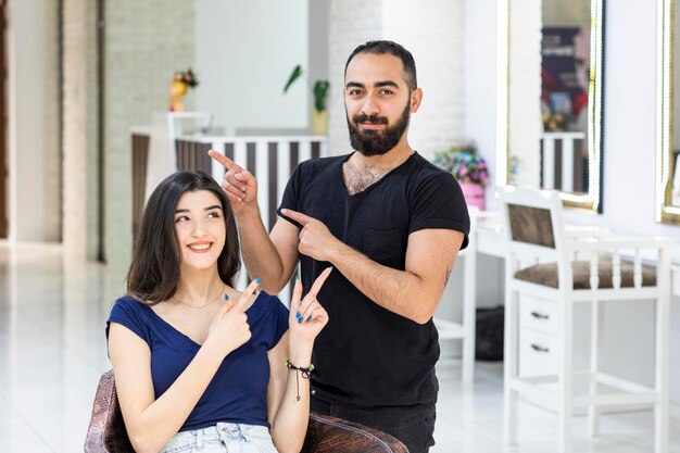 Young lady smiling and point finger to her client High quality photo