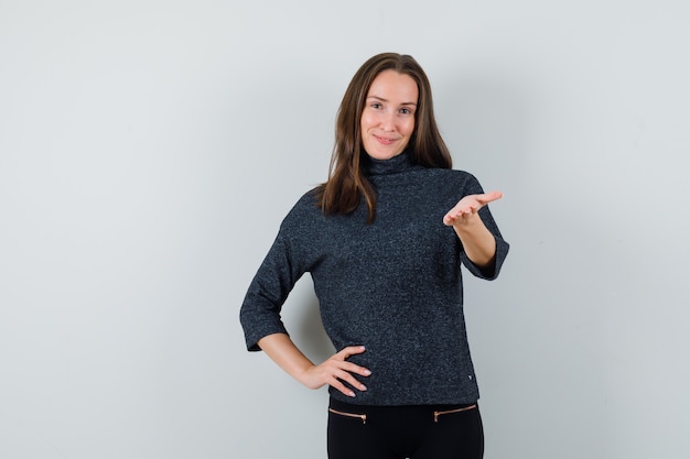 Young lady stretching hand in shirt