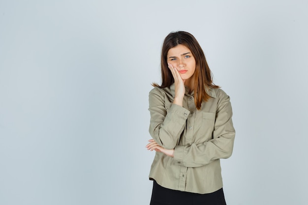 Free photo young lady suffering from toothache in shirt, skirt and looking painful. front view.