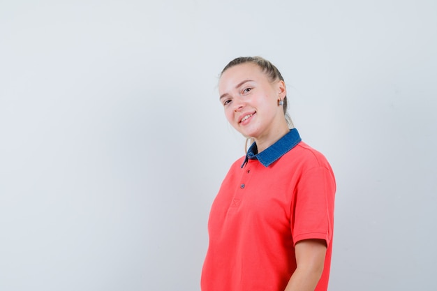 Young lady in t-shirt and looking cheerful