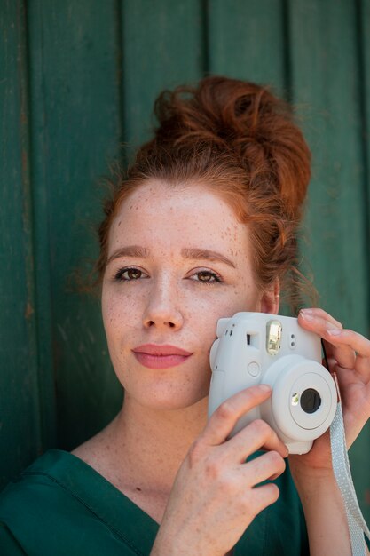 Young lady using a vintage camera