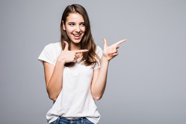 Young lady in white t-shirt and blue jeans in front of white studio background