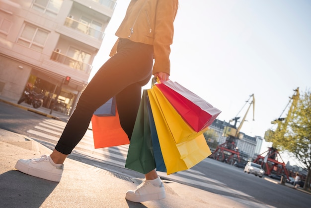 Young lady with shopping bags on street