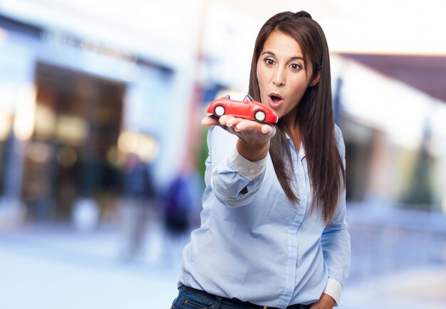 Young lady with a toy on her hand