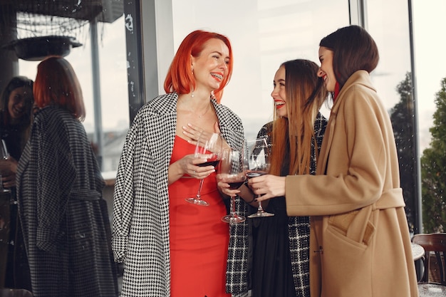 Free photo young laughing friends drinking rose wine from glass outside.