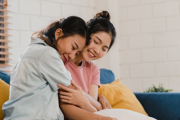 Free photo young lesbian lgbtq asian women couple hug and kiss at home