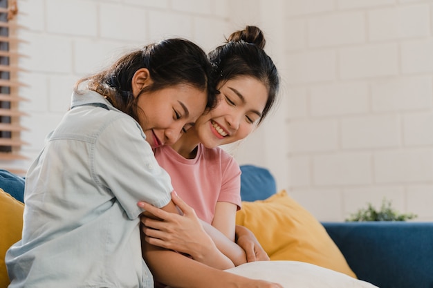 Young Lesbian lgbtq Asian women couple hug and kiss at home