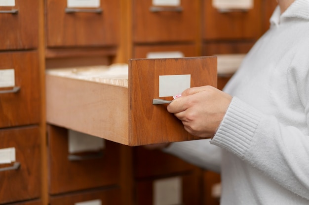 Free photo young librarian organising books