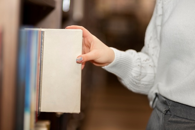 Young librarian organising books