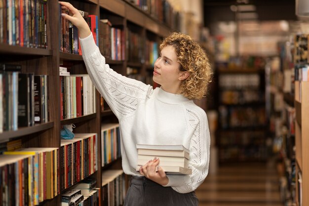 Young librarian organising books