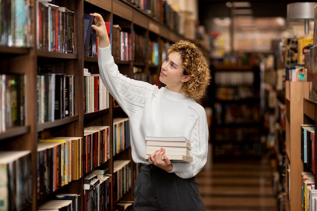 Free photo young librarian organising books