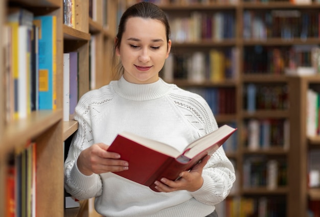 Young librarian organising books