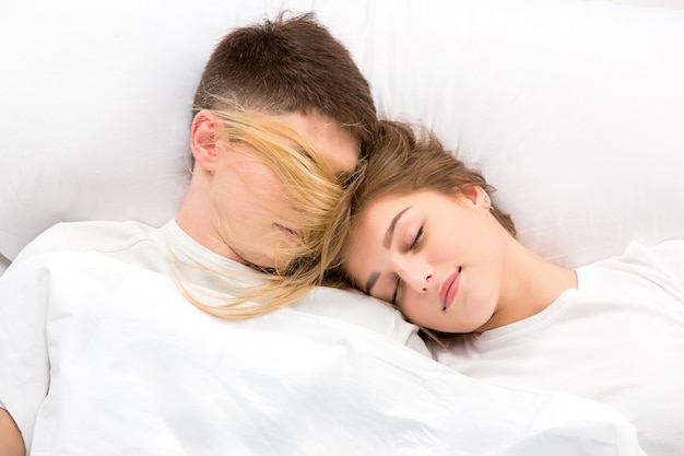 The young lovely couple lying in a bed