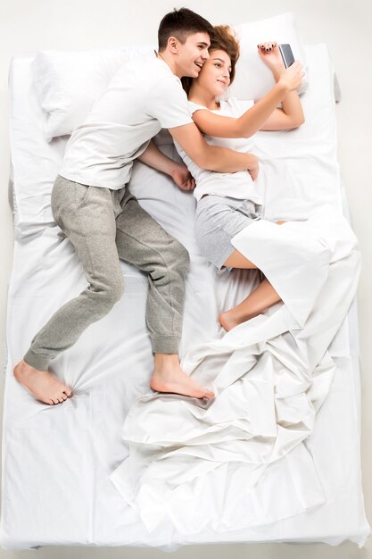 The young lovely couple lying in a bed