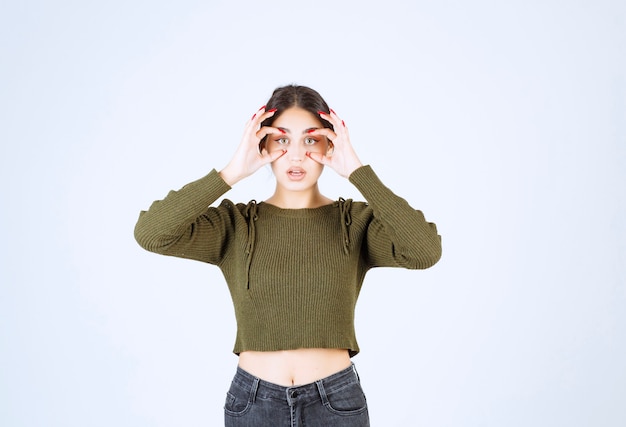 A young lovely woman model with binocular eyes standing on white background