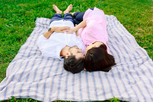 Young loving couple lying together enjoying closeness