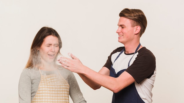 Free photo young loving couple playing with flour