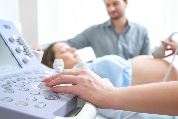 Free Photo young loving pregnant couple visiting doctor together
