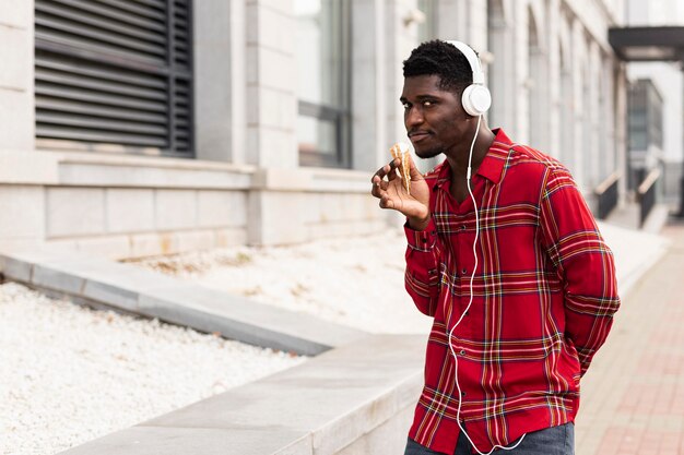 Free photo young male adult dancing and listening to music