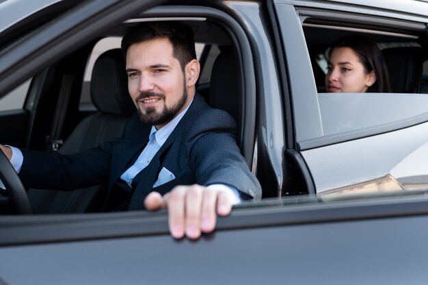 Young male being an uber driver for a female client